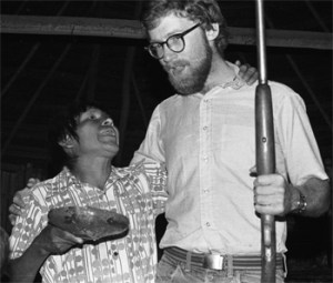 The author dances with an Awajún friend at a beer party, 1977.  The shotgun belonged to his dance partner.