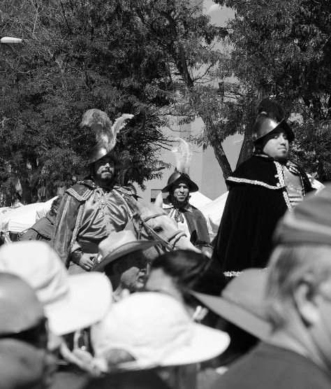 Dignitaries dressed as Spanish conquistadores attempt to ride through a crowd of protesters during the 2016 Entrada in front of the Palace of the Governors.